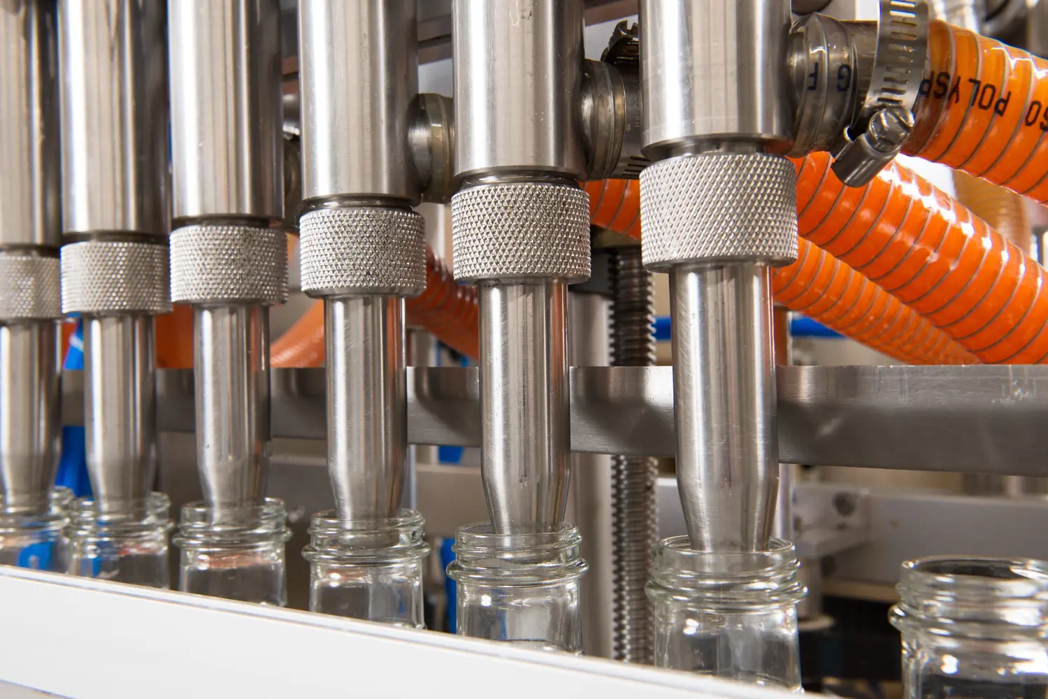 Clean close-up of the six-head filling equipment